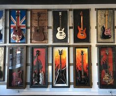 there are many guitars hanging on the wall