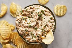 a bowl filled with dip surrounded by chips