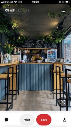 the interior of a restaurant with wooden tables and stools