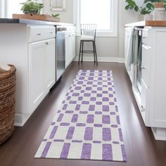 a purple and white runner rug in a kitchen