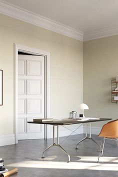 an empty room with a desk, chair and bookshelf on the floor in front of it