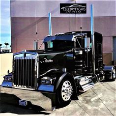 a large semi truck parked in front of a building