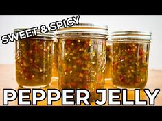 three jars filled with pickled peppers sitting on top of a wooden table next to the words sweet & spicy pepper jelly