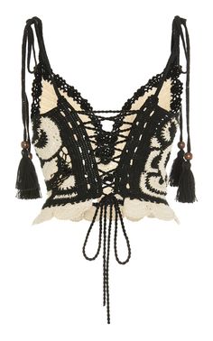 a black and white top with tassels on it