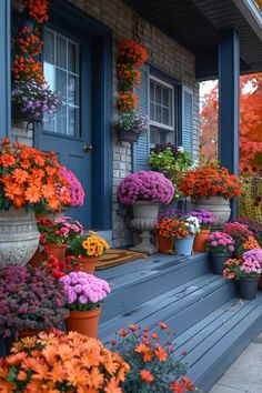 colorful flowers line the front porch of a house