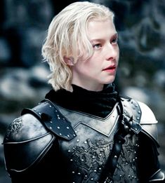 a woman with blonde hair wearing armor