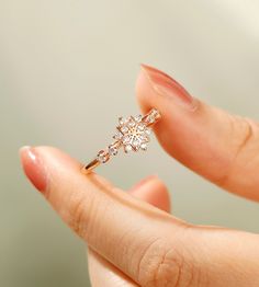 This is a Dainty Moissanite Ring, meticulously crafted from solid gold. It features a unique snowflake design, embodying minimalist elegance. Perfect as a statement ring, it is ideal for promises, weddings, or anniversaries. The moissanite gemstone adds a brilliant sparkle, making it a stunning choice for any special occasion. Its delicate and sophisticated style makes it a perfect gift for women who appreciate refined and timeless jewelry. Welcome to HeroWing, we promise all the rings are 100% hand-crafted it is cut and polished by our experienced craftsman. DETAILS *  Matal Type: 10K Gold/ 14K Gold *  Custom Gold Color: Rose Gold, Yellow Gold, White Gold *  Stones: Moissanite (High Quality) *  Total weight: 0.26ctw  WHY YOU'LL LOVE IT * A beautiful jewelry piece with deep sentimental val Fine Jewelry Snowflake Jewelry For Anniversary, Wedding Diamond Jewelry With Snowflake Design, Dainty Diamond Ring With Halo Design For Gift, Rose Gold Moissanite Cluster Ring As A Gift, Diamond White Cluster Ring With Open Shape, Delicate Halo Rings For Gift, Delicate Halo Design Rings For Gift, Delicate Halo Design Ring As Gift, Delicate Moissanite Ring Gift