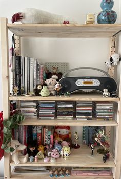 a bookshelf filled with lots of toys and stuffed animals on top of it