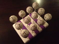 there are many chocolate candies on the plate and one is white with purple stripes