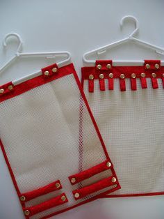 two pieces of red and white mesh hanging on clothes pins with gold studdings