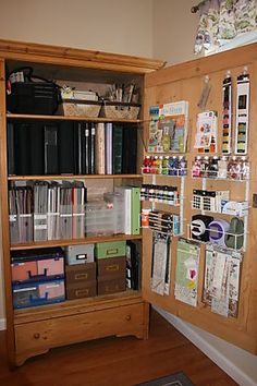 a wooden bookcase filled with lots of books next to a wall covered in pictures