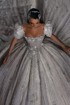 a woman in a silver ball gown with sequins