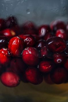 cranberries are in a glass bowl with water