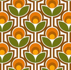 an orange and green flower pattern on a white background with brown circles in the center