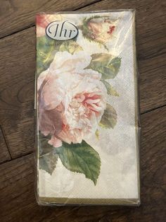 a package with flowers on it sitting on top of a wooden table