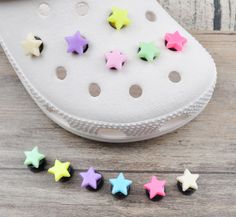 several small stars are placed next to a pair of white shoes