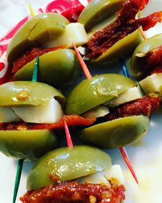 green peppers with bacon and toothpicks on a plate