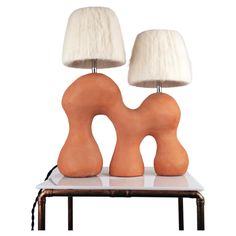 two wooden lamps sitting on top of a table