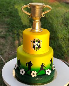 a yellow and green cake with soccer decorations