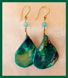 Enjoy a lovely pair of hand made Ocean Design dangle earrings.  These earrings are perfect for ocean lover, or a night out on the town. Each pair of earrings are constructed with love and care. Our earrings are made with Nickle free ear wire. These earrings are hand crafted with shell beads in ocean colors of Teal Blue and Green. Earrings Measure Approx: 1 inch Wide  X  1.50 inches Long If you have any questions prior to purchase please message us through Etsy Thank You! Handmade Ocean-inspired Drop Earrings, Unique Green Teardrop Earrings For Gift, Ocean-inspired Dangle Single Earring, Ocean-inspired Single Dangle Earring, Green Dangle Earrings For Beach, Ocean-inspired Drop Earrings For Gifts, Ocean-inspired Drop Earrings Gift, Ocean-inspired Drop Earrings For Gift, Ocean-inspired Single Earring As Gift