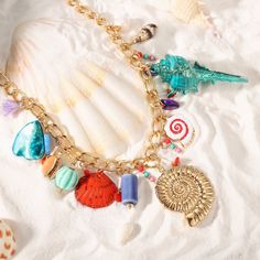 Golden days, starry nights, and sun-kissed jewelry. Elevate your style this summer with Selenichast jewelry. Boho Beach Vibes: Sea Shell Necklace. Channel your inner mermaid with this delightful Shell Charm Necklace. It features an assortment of sea shells, ceramic beads, and freshwater pearls, all strung on a delicate chain. The perfect beach accessory, this charms necklace adds a touch of boho chic to any outfit. Wear it with a flowing summer dress or swimsuit for a touch of coastal flair, or Flowing Summer Dresses, Shell Charm Necklace, Sea Shell Necklace, Coastal Jewelry, Ocean Fashion, Starry Nights, Golden Days, Charms Necklace, Seashell Necklace