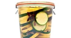 a jar filled with sliced cucumbers and other vegetables