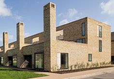 a large brick building sitting on top of a lush green field