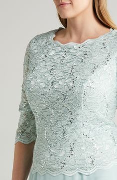 Scalloped stretch lace alight in sequins layers the bodice of this formal dress with a flowing chiffon skirt that gives the illusion of coordinated separates. 47" length (size 18W) Hidden back-zip closure Bateau neck Elbow-length sleeves Bra friendly Lined, except sleeves 58% nylon, 40% polyester, 2% spandex with 100% polyester contrast Hand wash, dry flat Imported Women's Clothing Elegant Lace Sequin Dress For Prom, Scalloped Lace Mother Of The Bride Dress For Party, Formal Dress With Lace Top And Fitted Bodice, Spring Gala Lace Mother Of The Bride Dress, Spring Gala Mother Of The Bride Lace Dress, Glamorous Lace Mother Of The Bride Dress With Sequins, Sequin Lace Evening Dress For Mother Of The Bride, Party Dress With Lace Top And Fitted Bodice, Elegant Lace Sequin Wedding Dress