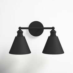 two black lamps are hanging on the wall next to each other in front of a white background