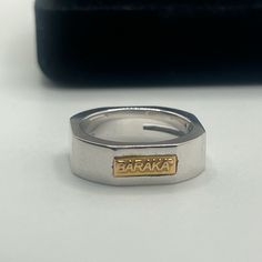 A Modern, Luxurious 18k White Gold Cut Baraka Branded Wedding Band Ring With Yellow Gold Detail And A White Diamond Detail Unisex/Mens/Womens Approximately .10ctw Marked 750 And Serial Number Weighs 11.1 Grams Ring Size 6-6.5 Luxury Silver Signet Ring For Wedding, Luxury Silver Wedding Signet Ring, Yellow Gold Engraved Wedding Ring, Luxury Stamped 925 Signet Ring For Wedding, Luxury 925 Stamped Signet Ring For Wedding, Formal White Gold Couple Rings Hallmarked, Formal Hallmarked White Gold Couple Rings, Luxury Wedding Signet Ring, Luxury White Gold Engraved Tarnish Resistant Ring