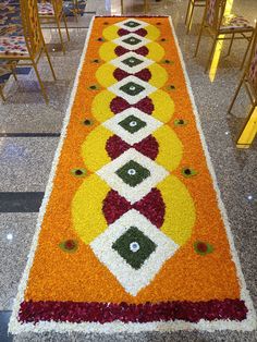 an orange and white carpet with flowers on it