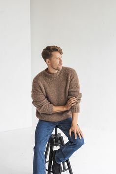 "This sweater is classic and never goes out of style, it's timeless. What makes this jumper exceptional? It is incredibly soft, warm and cozy, crafted from premium alpaca wool and silk.  DETAILS - Handmade. Our skillful knitters knit each garment by hand in their own homes and we are happy to provide them with the opportunity to support themselves while doing something they love. - Composition: alpaca wool and silk. No synthetic blends, for you and the environment. - Brown color. You can choose any other color listed in the last photo. - Regular fit. The model wearing size M and she is 184 cm/6\" tall. - Alterations are available. Please just let us know. - Orders are nicely packaged in tissue paper or cotton dust bags, and the option of a gift box with a satin ribbon is available to make Men’s Beige Sweater Outfit, Wool Sweater Men Outfit, Light Brown Sweater Outfit, Sweater Men Outfit, Minimalist Mens Fashion, Jumper Outfit Men, Beige Sweater Outfit, Tall Men Fashion, Alpaca Wool Sweater