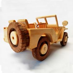 a wooden toy truck is shown on a white surface