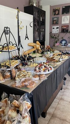 an assortment of breads and pastries on display at a buffet table in a restaurant