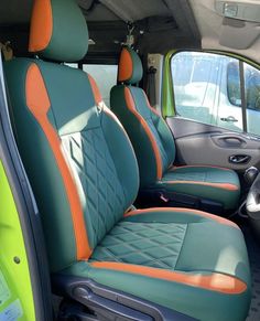 the interior of a vehicle with green and orange seats