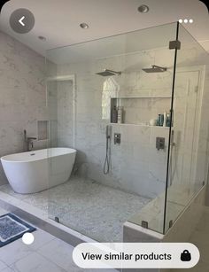 a bathroom with a large tub and walk in shower next to a white tiled floor