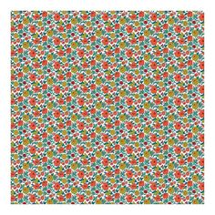 an orange and green flowered pattern on white paper with red, green, yellow, and blue flowers