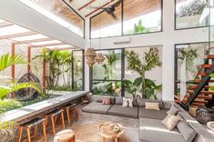 a living room filled with furniture and lots of plants