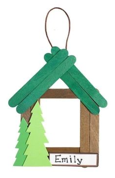 an ornament shaped like a house with trees on it