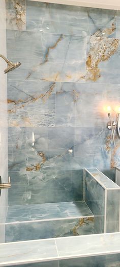 a bath room with a sink and a bath tub next to a wall mounted mirror