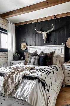 a bed room with a neatly made bed and a cow skull on the wall above it