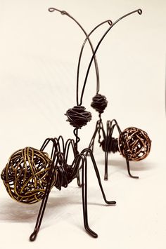 three wire sculptures are standing on top of each other