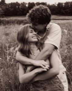 a man hugging a woman in a field