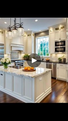 a large kitchen with white cabinets and an island in the middle of the room is shown