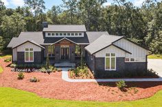 this is an aerial view of a house in the woods with lots of trees and grass