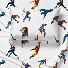 the bedding is decorated with superheros and captain america characters on white sheeting