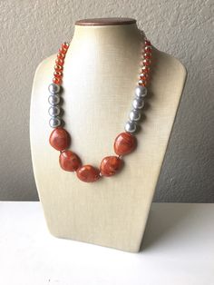 A single strand of statement beads in shades of rust / burnt orange and silver. Approximately 16 inches, with a 4 inch chain and silver plated lobster clasp. Need MORE necklaces? Send me a message :) *Smoke and pet free home!* I ship 6 days a week! Thank you for browsing my store! Handmade Orange Long Necklace, Handmade Orange Necklace, Unique Orange Long Necklace, Orange Faceted Beads Jewelry, Orange Faceted Beads For Jewelry Making, Orange Faceted Beads For Crafting, Unique Long Orange Necklace, Unique Orange Necklace With Large Beads, Unique Orange Beaded Necklaces