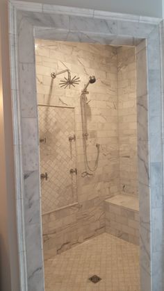 a walk in shower sitting inside of a bathroom