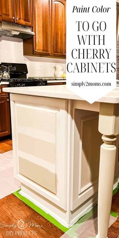 a kitchen island painted in white with the words paint color to go with cherry cabinets