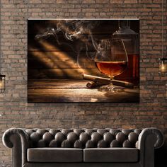 a glass of wine sitting on top of a couch next to a brick wall